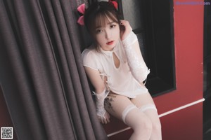 A woman in a white dress and red shoes posing for a picture.