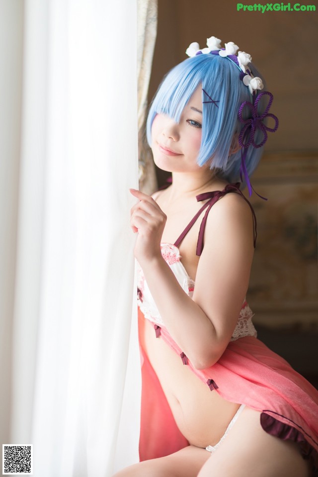 A woman with blue hair and a flower crown on her head.