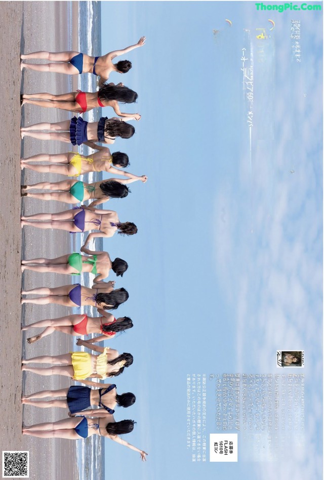 A group of women in bikinis standing on a beach.