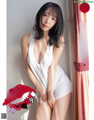 A woman in a red lingerie sitting on a green chair.