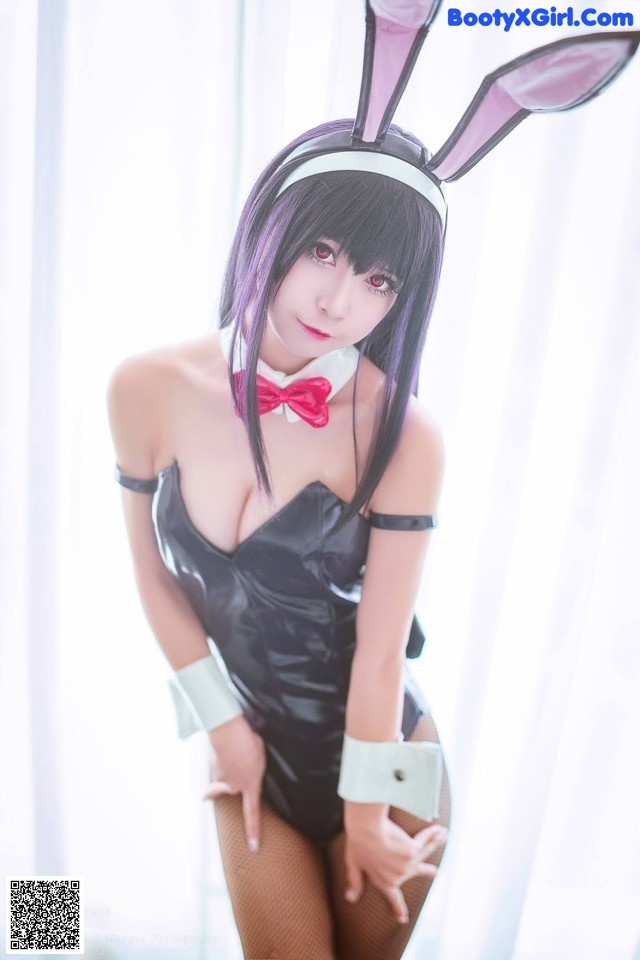 A woman in a bunny costume posing for a picture.