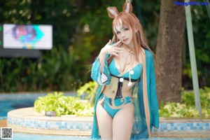 A woman in a bikini standing in a pool.