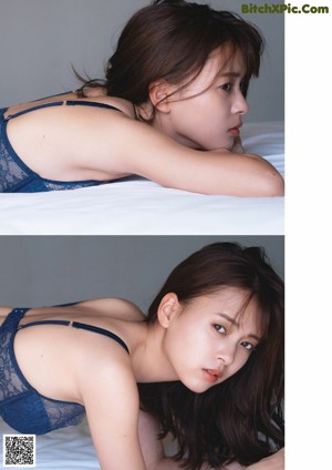 A young woman laying on top of a black blanket.