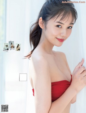 A woman in a white kimono is posing for a picture.