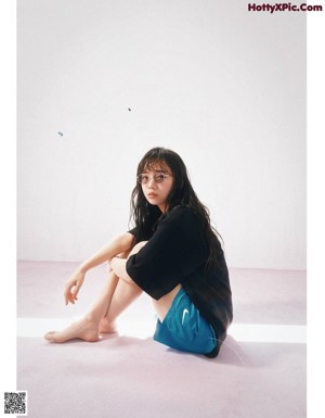 A magazine spread with a woman in a t-shirt and shorts.