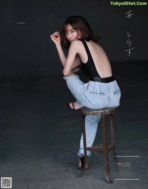 A magazine spread with a woman leaning against a wall.