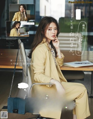 A woman standing in front of a window with a handbag.
