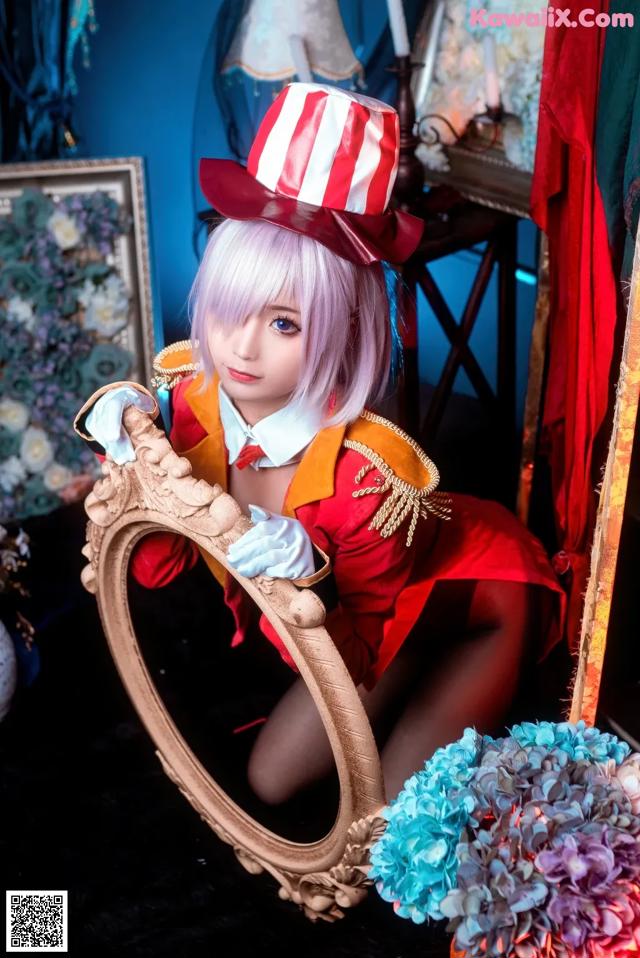 A woman in a red and white outfit holding a mirror.