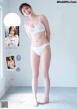 A woman in a bikini sitting on the ground next to a window.