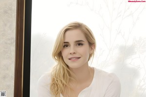 A young woman in a white bra and black skirt posing for a picture.