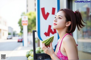 a woman in a white tank top holding a bottle of water